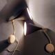 Pair of bedroom sconces in gilded brass and black aluminum 1960.
