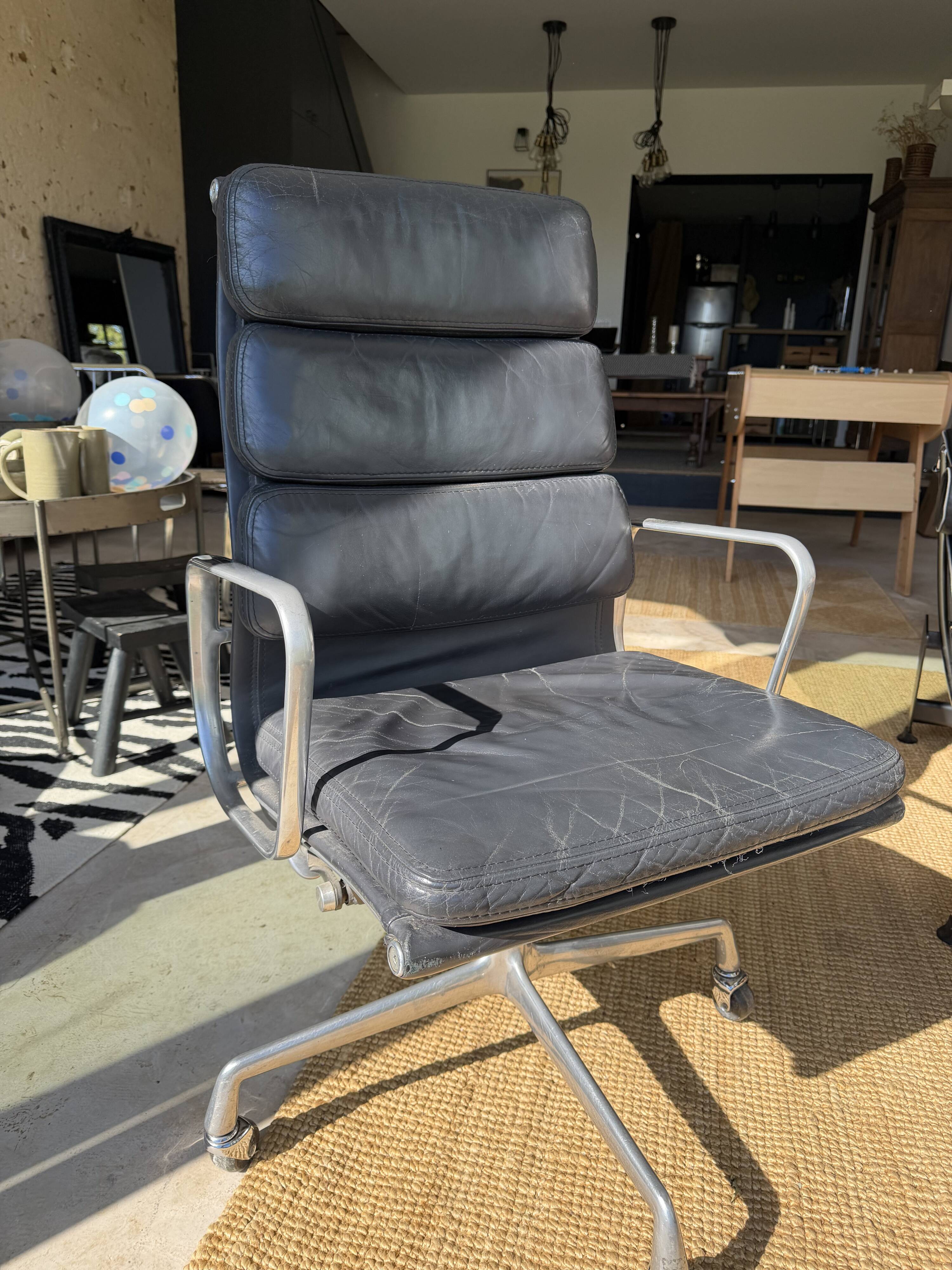 Eames soft pad chair in black leather, Herman Miller edition.