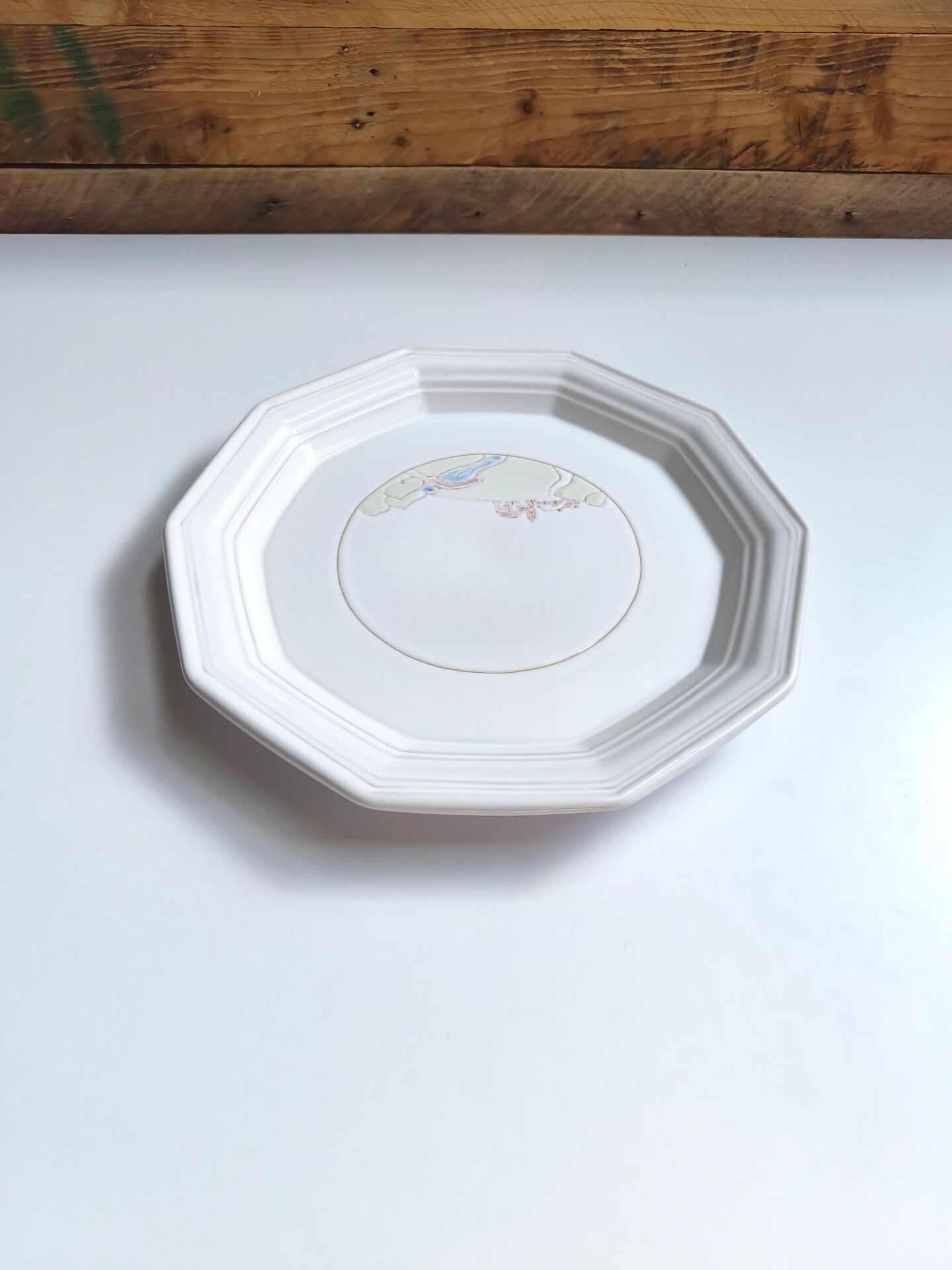 Round vintage Niderviller plate with a country decor.