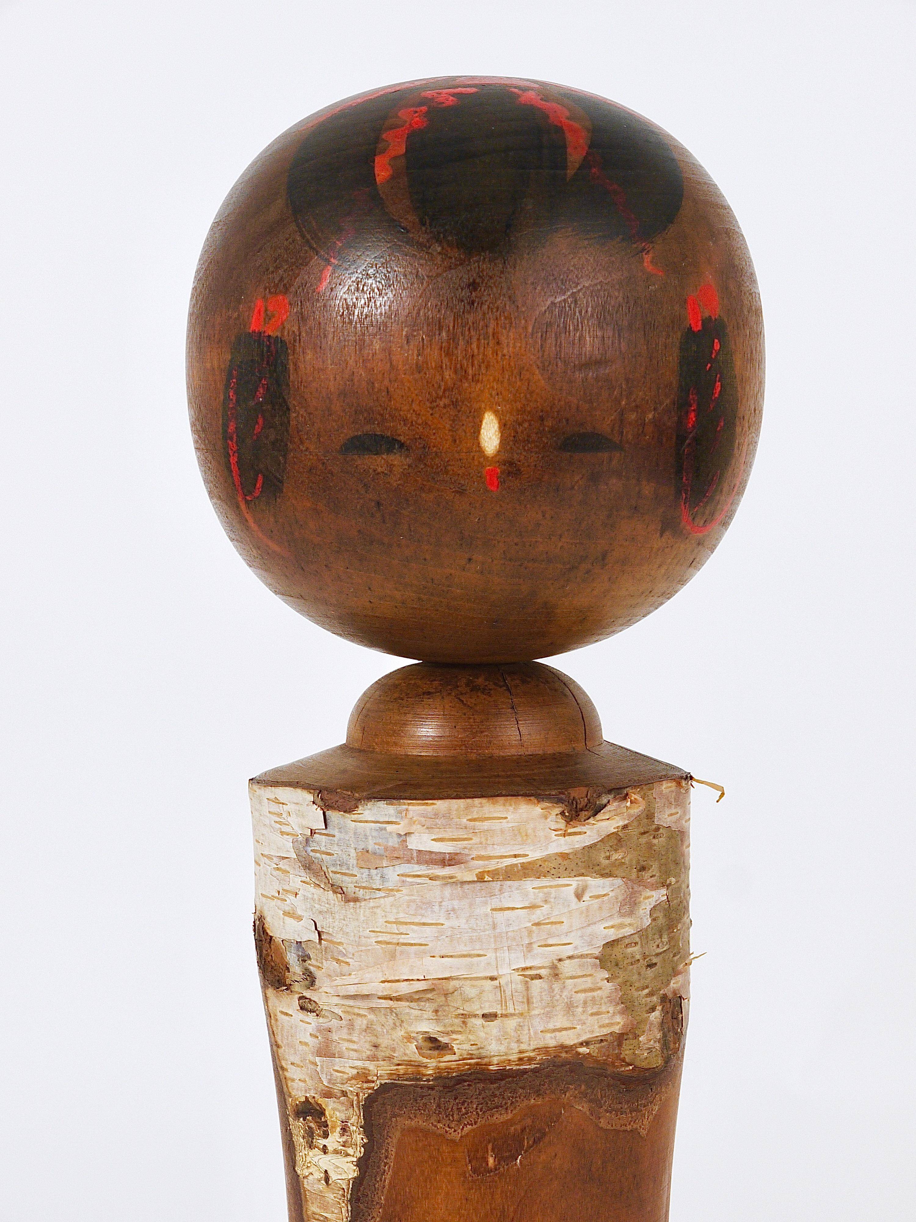 Decorative Kokeshi doll sculpture from northern Japan, hand-painted.
