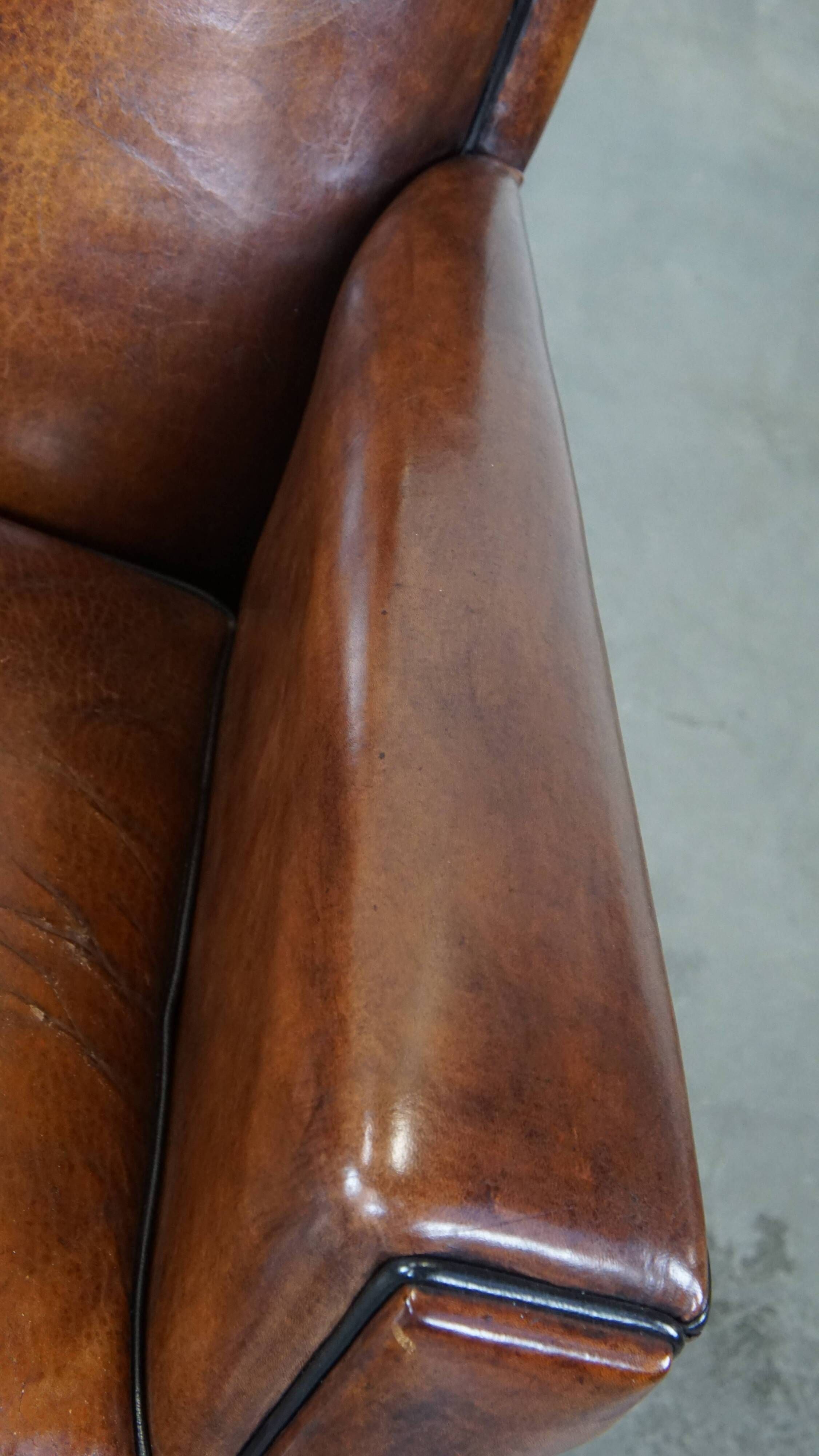 Cognac-colored sheep leather Art Deco design armchair finished with piping