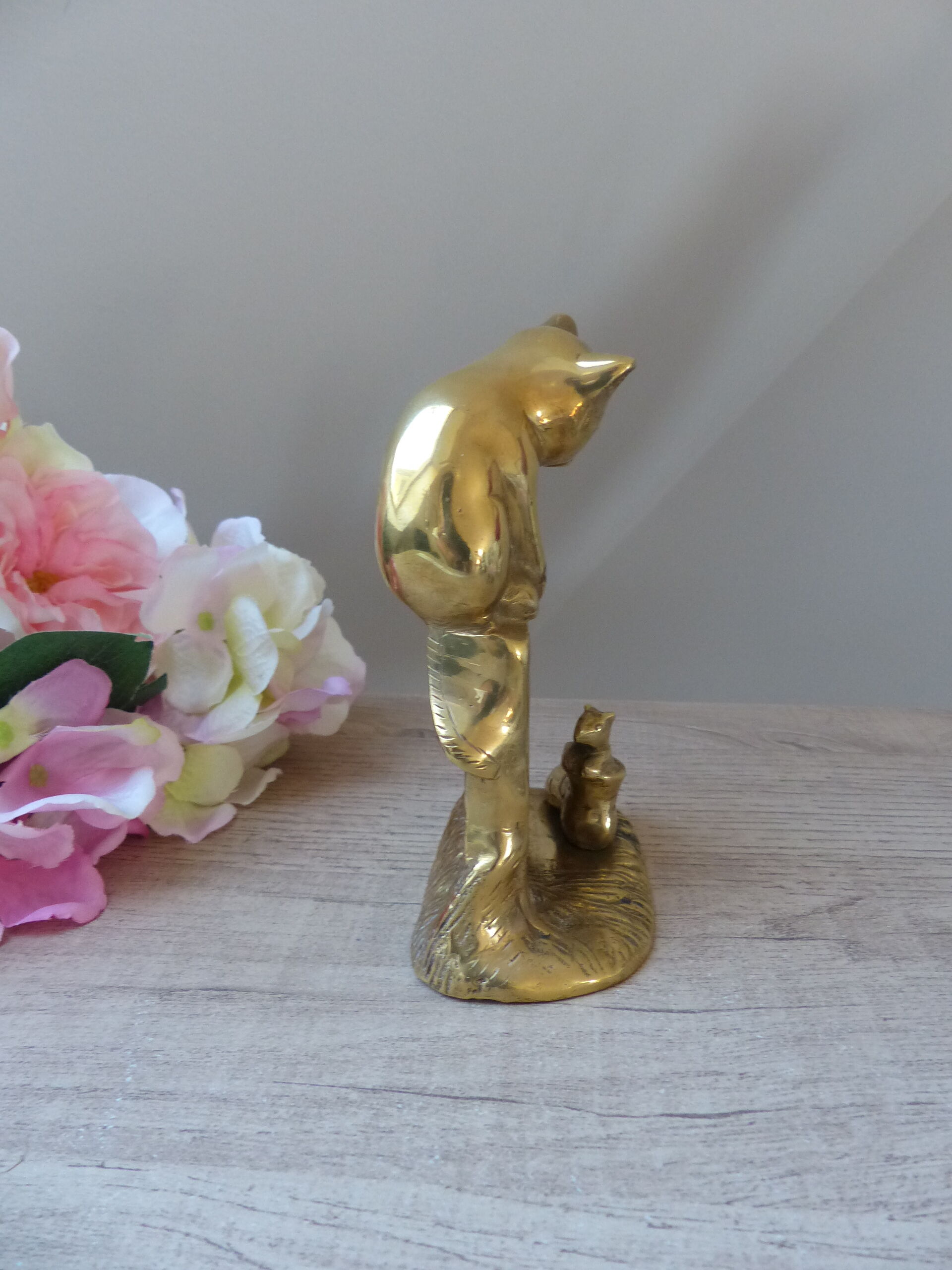 Golden brass cat figurine on fence looking at a mouse in a Vintage India shoe