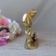 Golden brass cat figurine on fence looking at a mouse in a Vintage India shoe