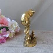 Golden brass cat figurine on fence looking at a mouse in a Vintage India shoe