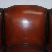 Restored Victorian sofa in leather with claw feet and feather cushions.