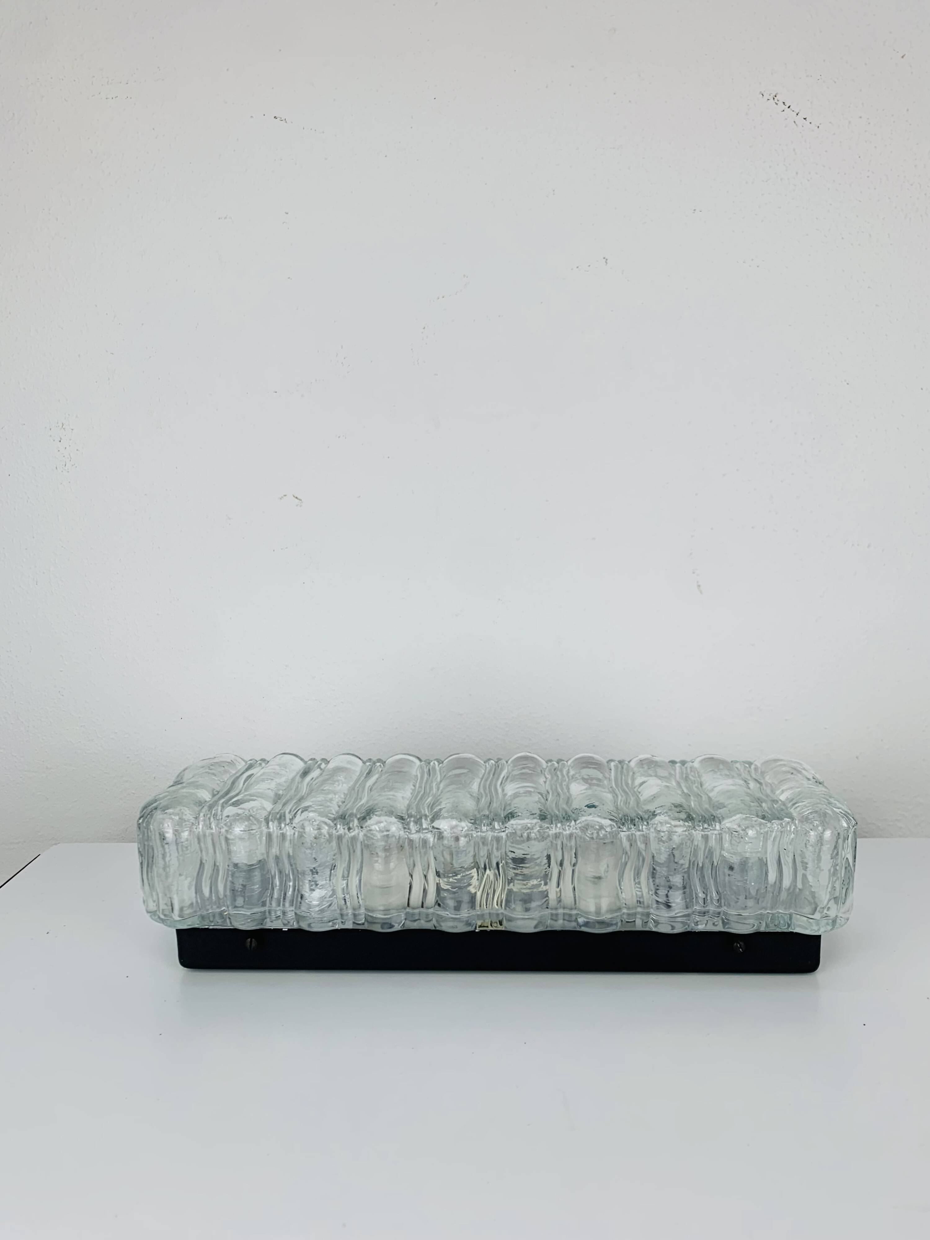 Rectangular wall lamp in molded glass and black metal from the 60s