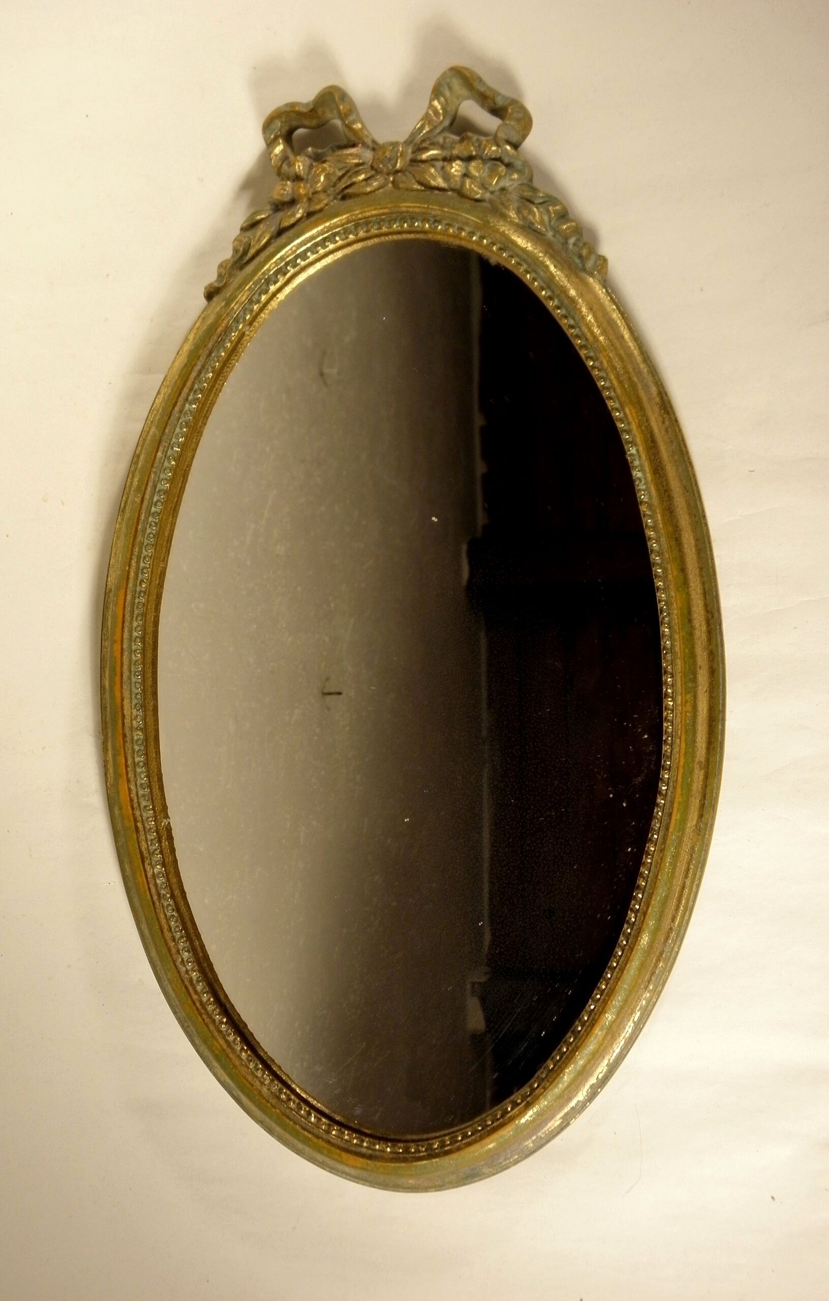 Golden oval mirror
