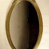 Golden oval mirror