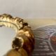 Small vintage oval wall mirror in varnished gold resin