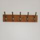 Wall-mounted coat rack with 5 vintage-style hooks in patinated wood and metal.
