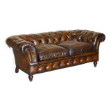 Victorian Chesterfield leather upholstered canapé with feather cushions.