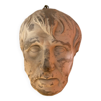 Plaster face wall statue