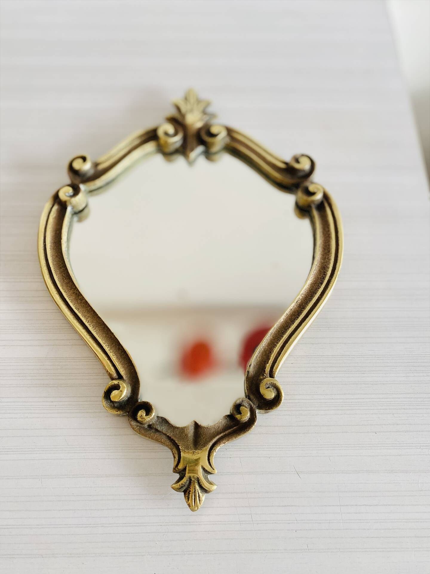 Small antique mirror in baroque style – gold frame in bronze or brass.