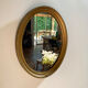 Oval mirror in gilded wood