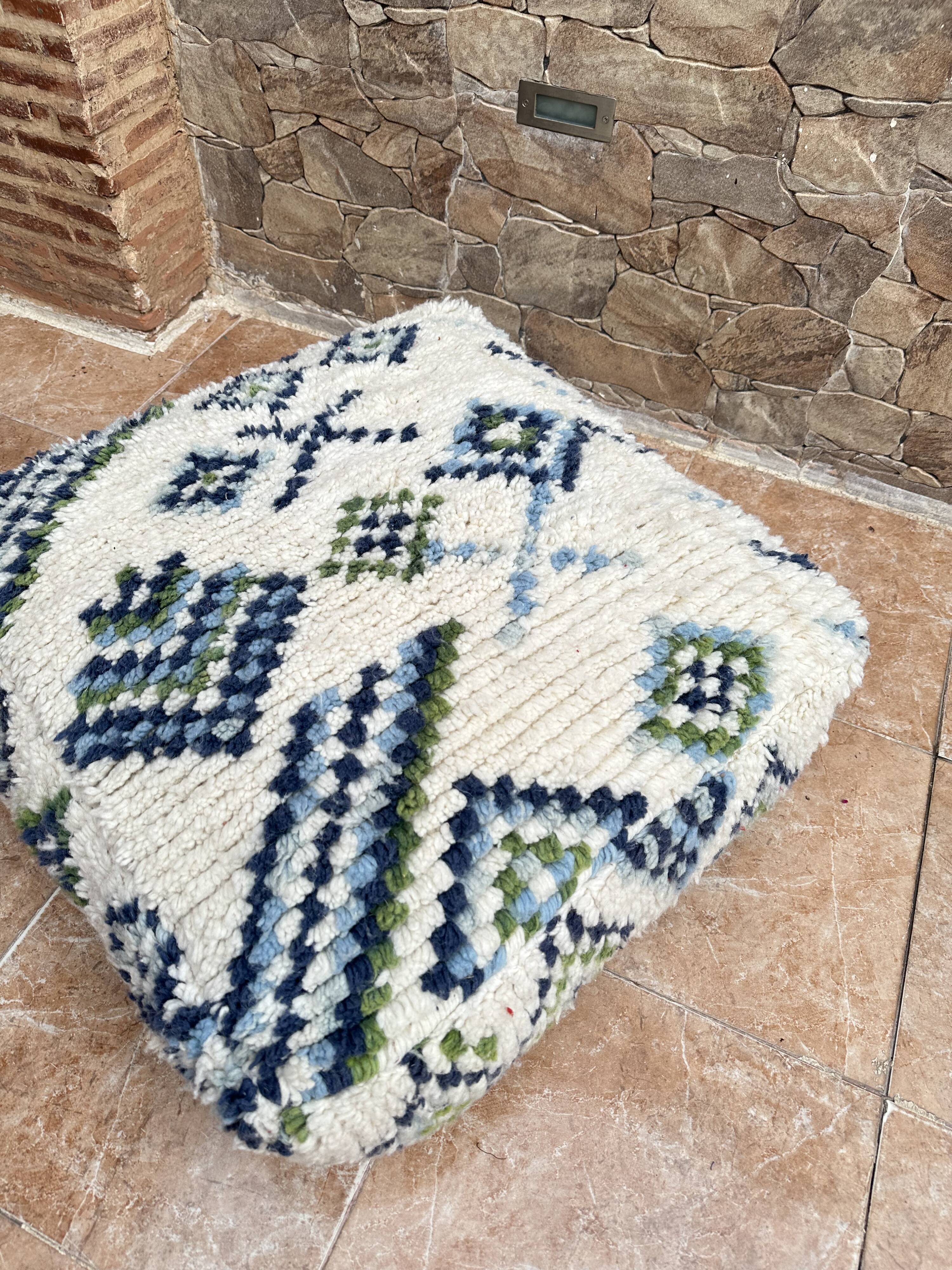 Berber floor pouf: Handwoven Moroccan wool cushion.