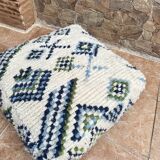Berber floor pouf: Handwoven Moroccan wool cushion.