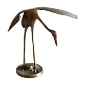 Bird takes off brass