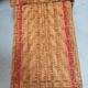Sunbathing sunbathing in wicker rattan wood deckchair red lounger