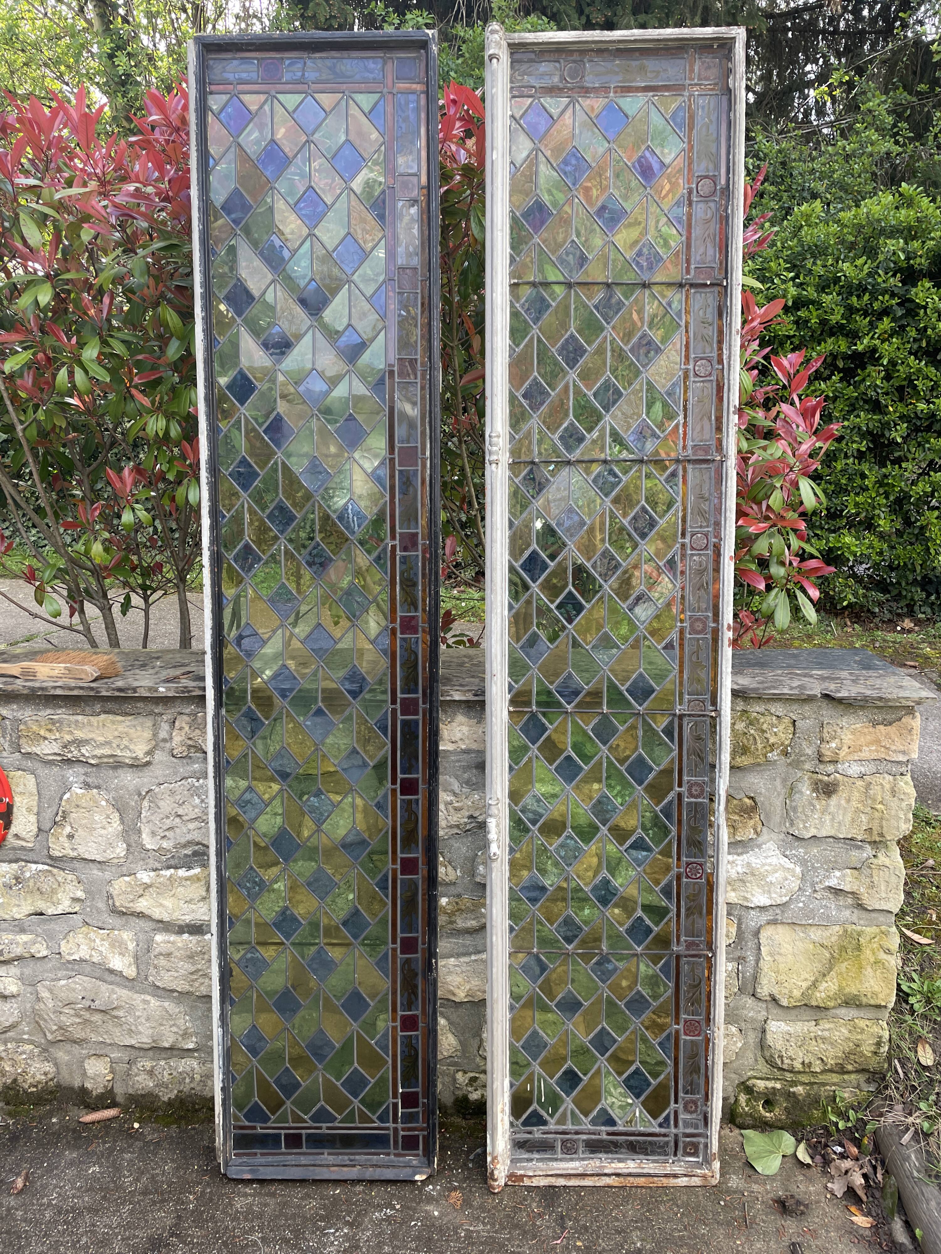 Pair of old double stained glass doors. Metal frames. Stained glass windows