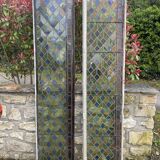 Pair of old double stained glass doors. Metal frames. Stained glass windows