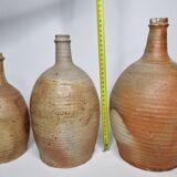 Set of three enamelled terracotta bottles