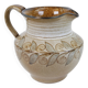 Glazed ceramic jug with plant decoration