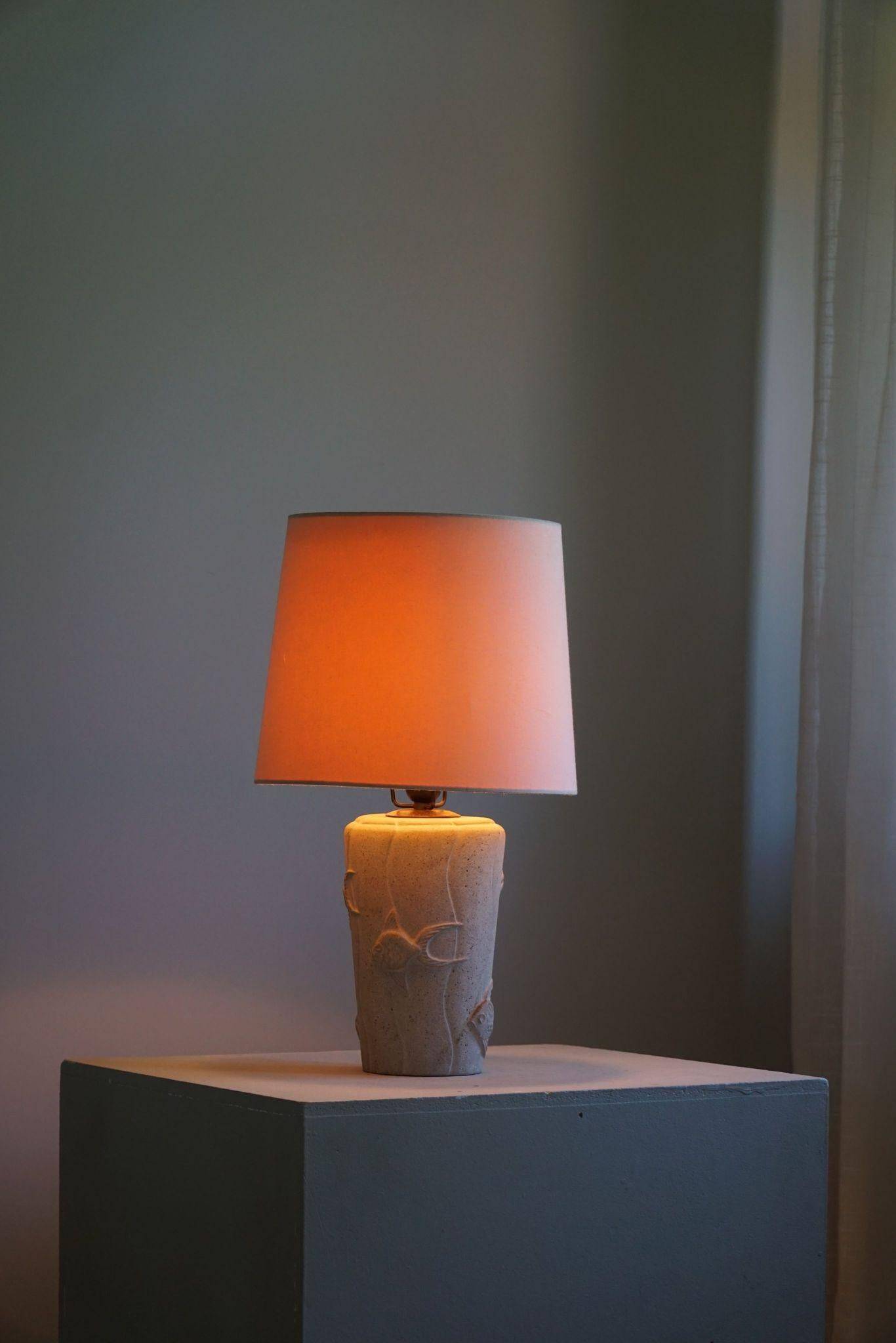 Modern vintage French table lamp, made of stone with fish patterns, 1970s.