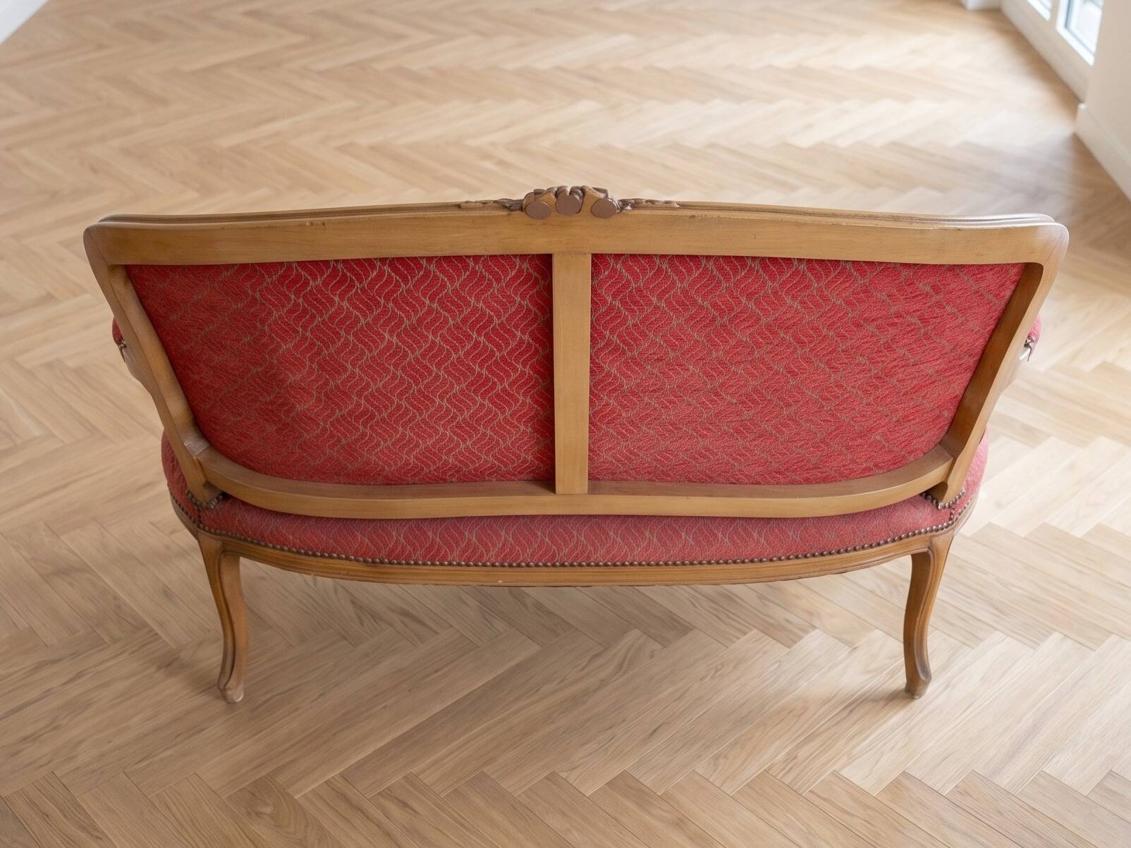 Two-seater Louis XV style sofa in red fabric.