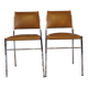 Pair of modernist chairs in chromed metal and imitation leather
