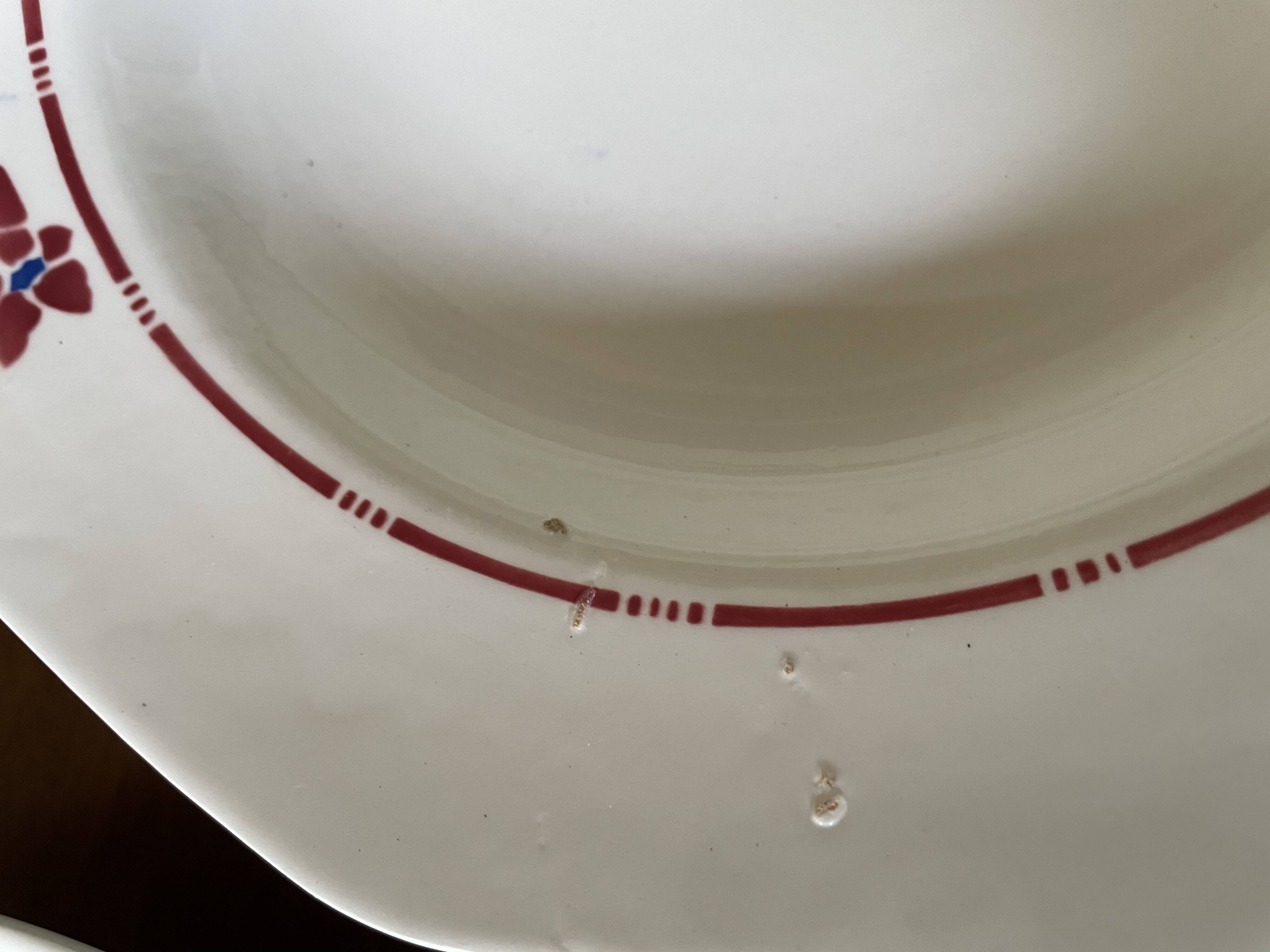 Saint Amand hollow plates decorated with red and blue flowers