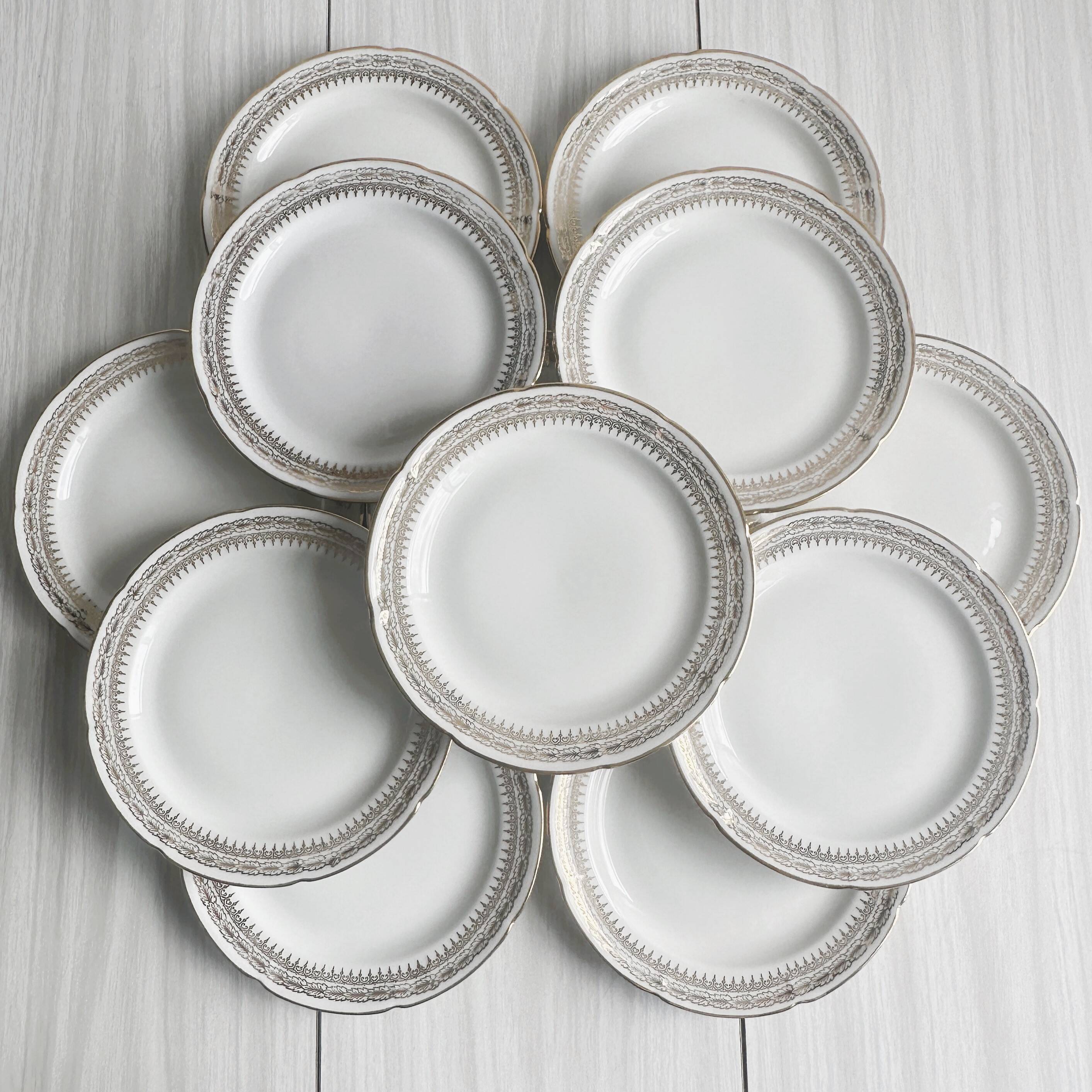 12 Limoges porcelain dessert plates, gold decoration.