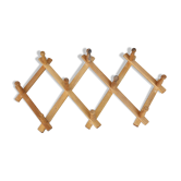 Vintage retractable wall-mounted coat rack made of pine wood