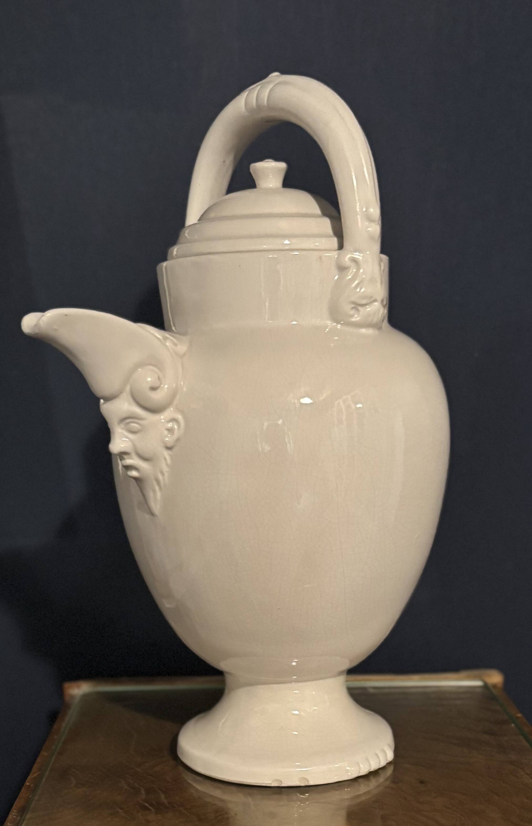 Large white faience jug with a satyr head spout, 19th century.