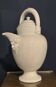 Large white faience jug with a satyr head spout, 19th century.