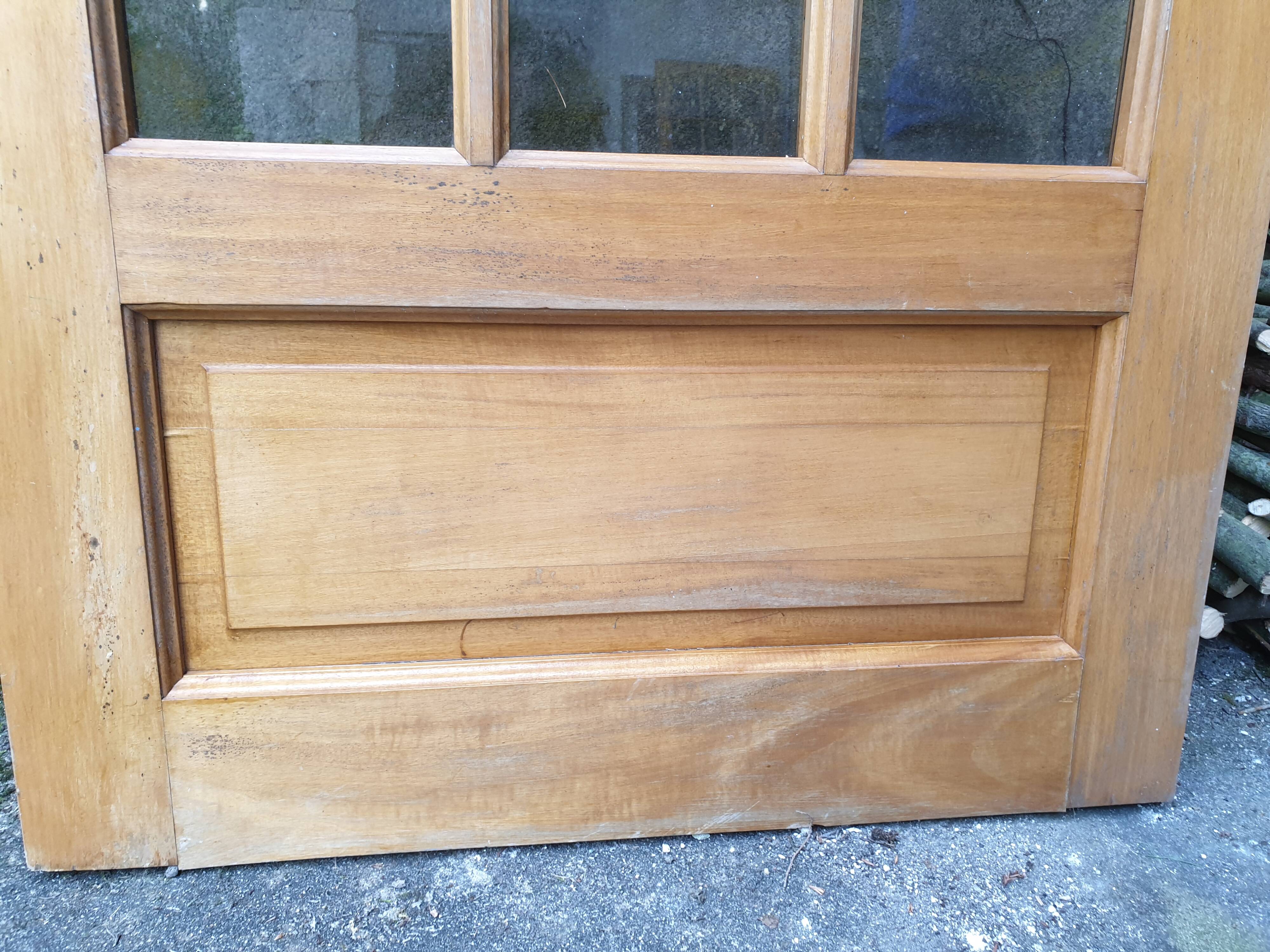 Old wooden door glazed with small tiles