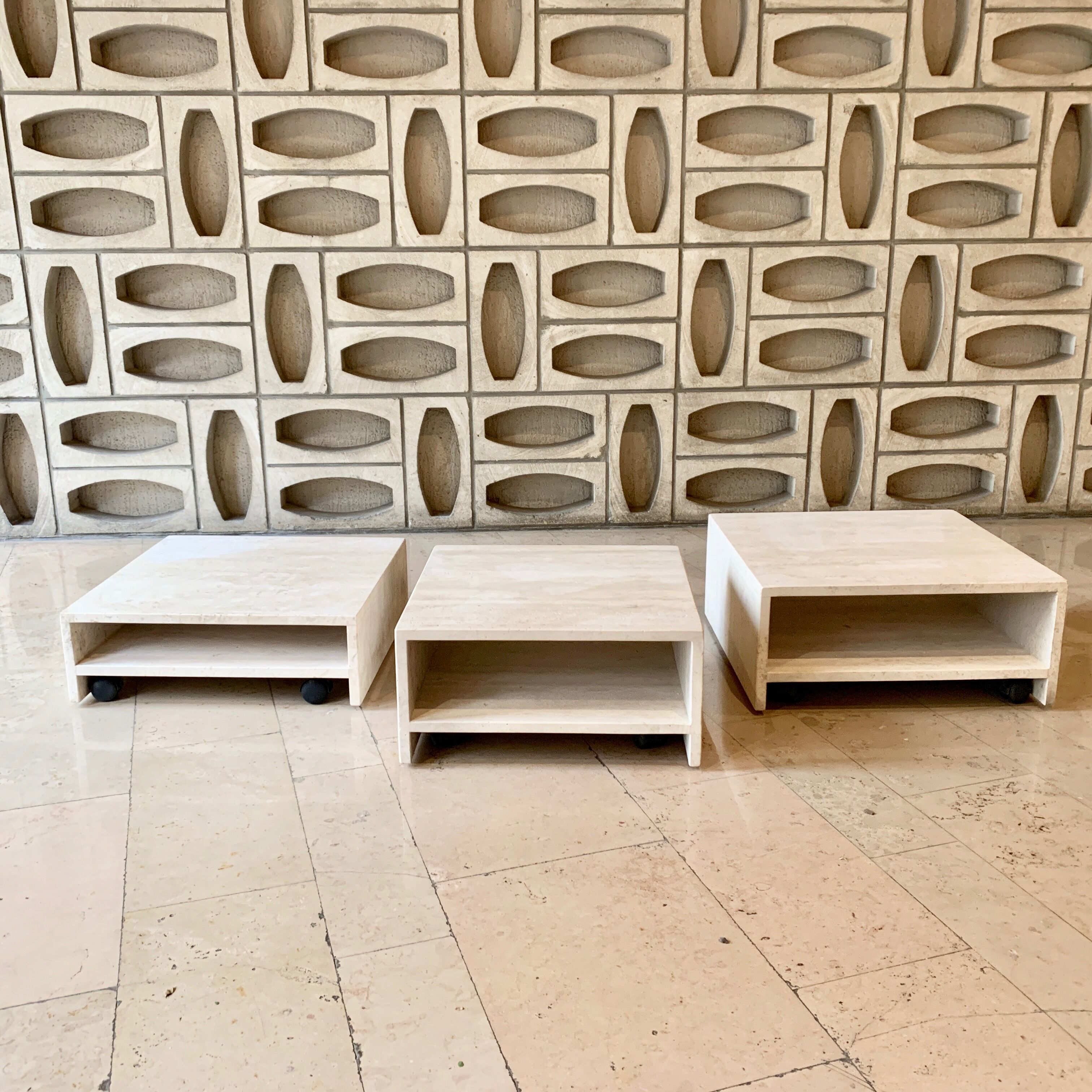Modular square coffee tables in softened travertine
