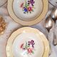 Old hollow plates mismatched in earthenware with gilded edges