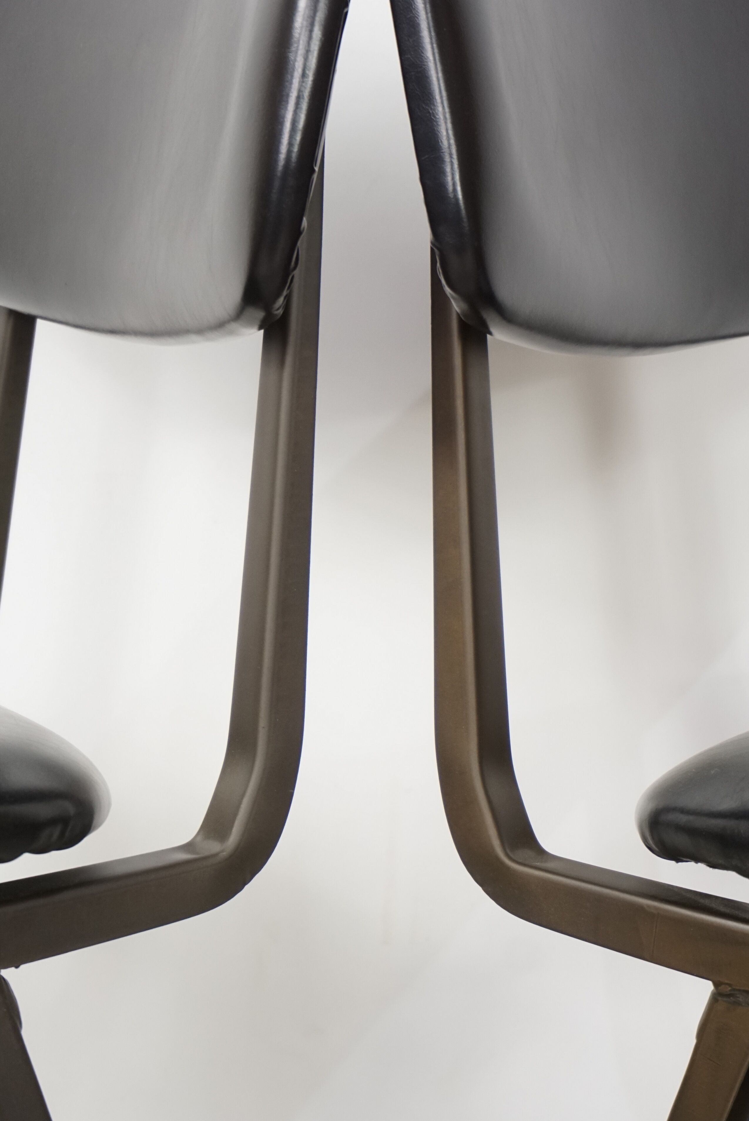Pair of industrial style chairs in metal and faux black leather