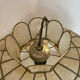 Large mother-of-pearl and brass chandelier with floral decoration.