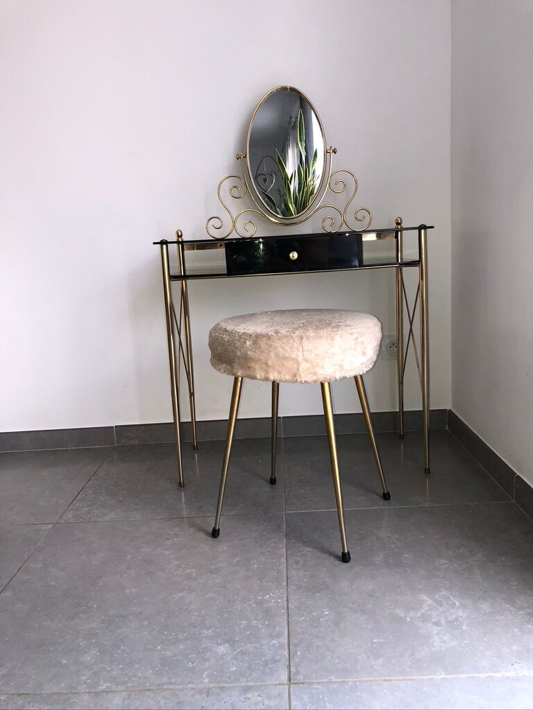 Brass hairdresser, glass and black plastic with its fluffy stool.