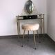 Brass hairdresser, glass and black plastic with its fluffy stool.
