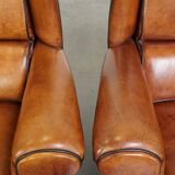 Set of 2 very comfortable large sheepskin armchairs elegantly finished with black piping