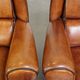 Set of 2 very comfortable large sheepskin armchairs elegantly finished with black piping