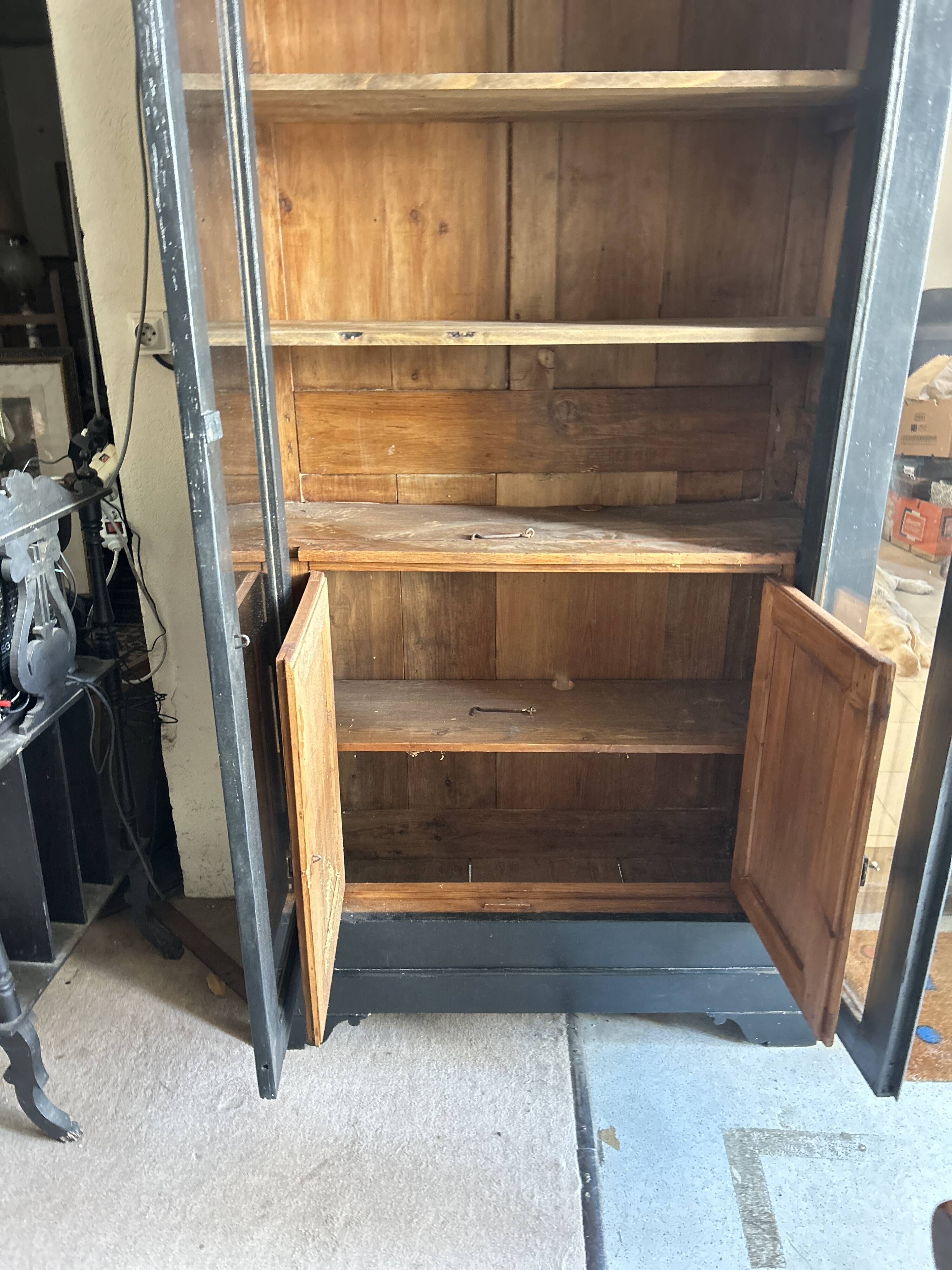 Black painted wardrobe with two glass doors and an interior sideboard.