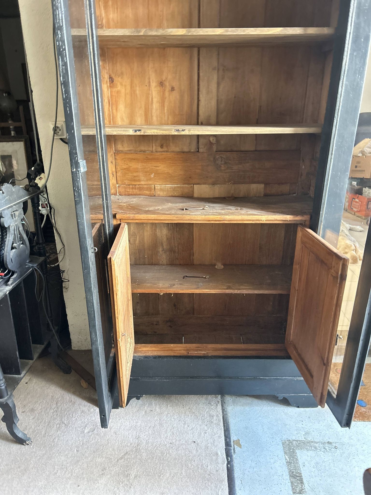 Black painted wardrobe with two glass doors and an interior sideboard.