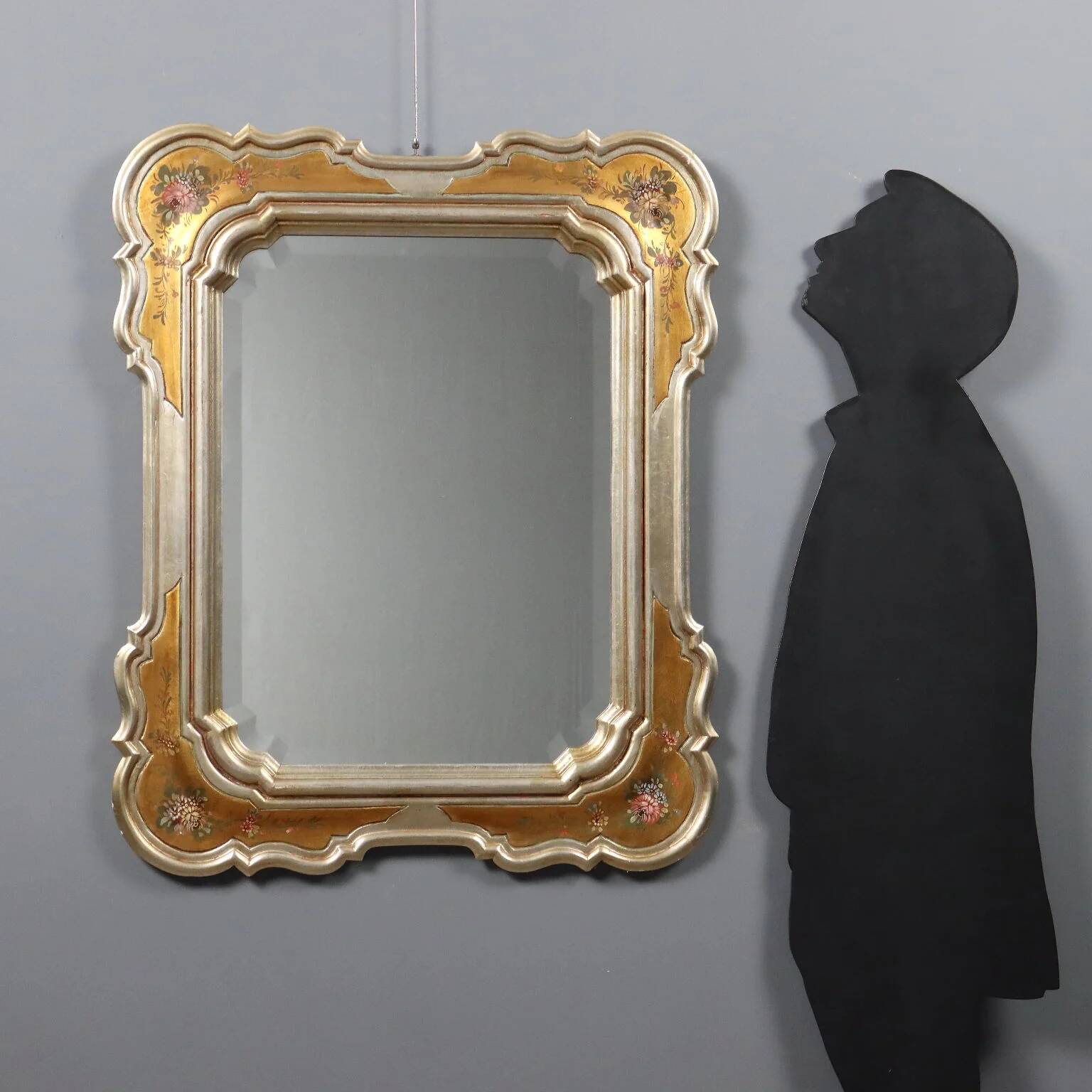 Antique mirror with a gilded frame and floral decorations, Italy, 20th century.