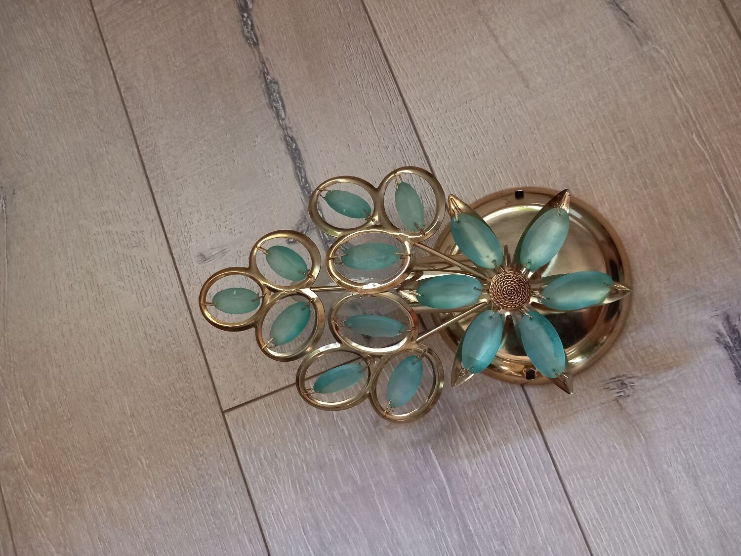 Gold metal wall light with light blue tassels