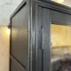 Aged patinated black display cabinet