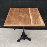 Bistro table with cast iron base and teak top