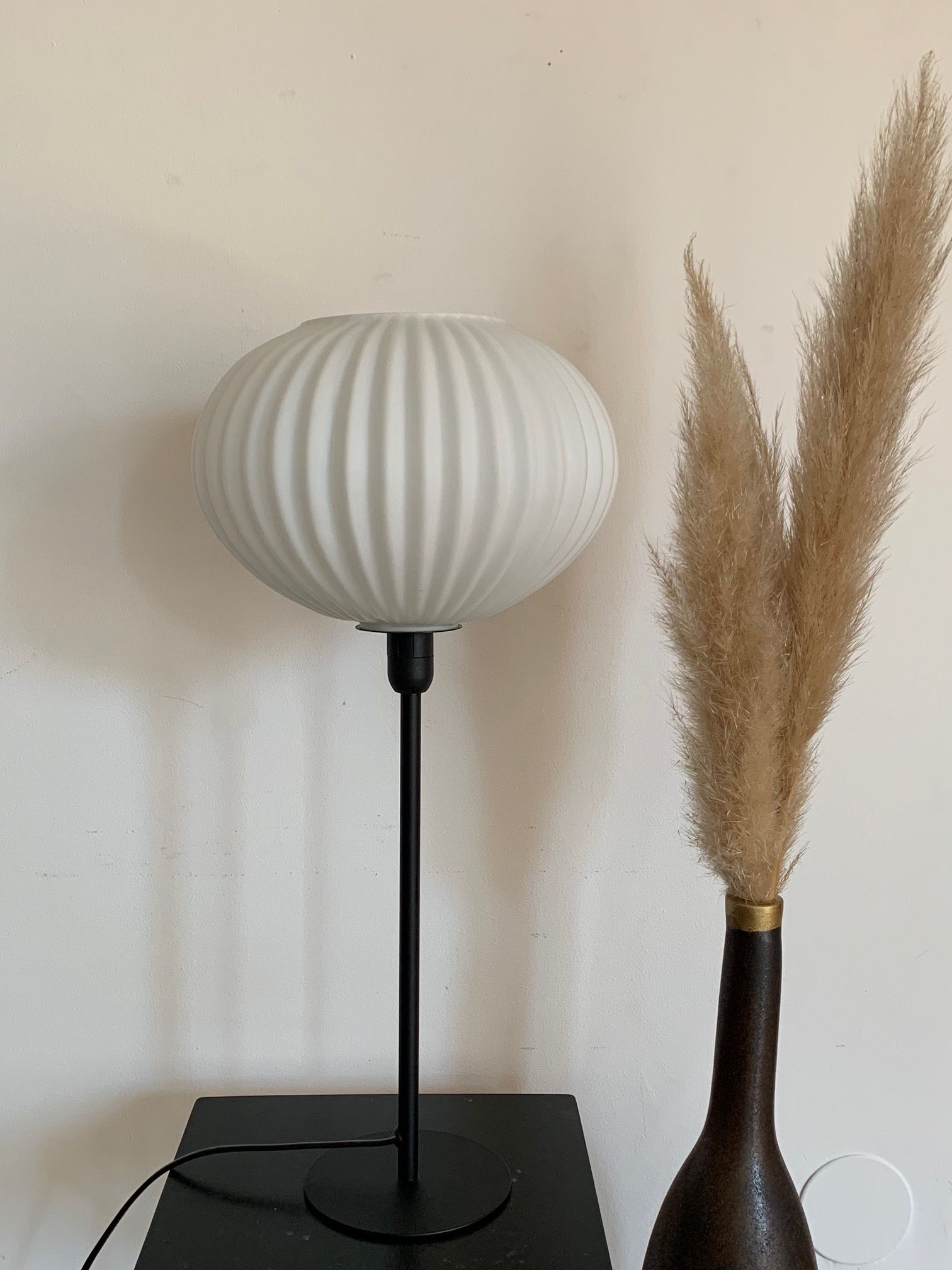 Table lamp with an antique white opaline lampshade and a vintage golden foot